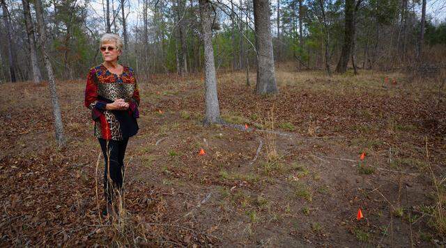 Debbie Jackson stands March 9, 2026, near what she believes are unmarked graves on her property in Muscogee County. Jackson lives near the proposed site for a hyperscale data center.