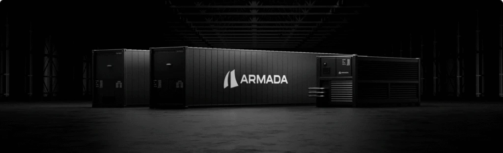 Armada Galleon modular datacenter units are arranged in a row in a dark industrial center, with the Armada name visible in the middle section.